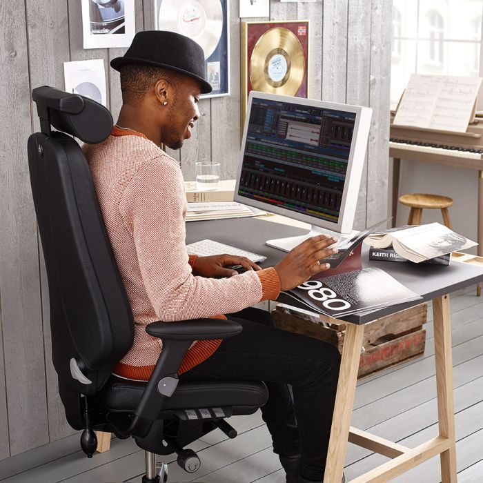 Image of a man sitting comfortably in a desk chair